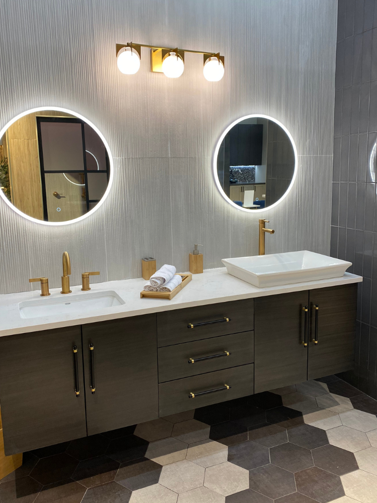 Black floating bathrooom vanity with two sinks, mirrors, and stylish blue cabinetry 