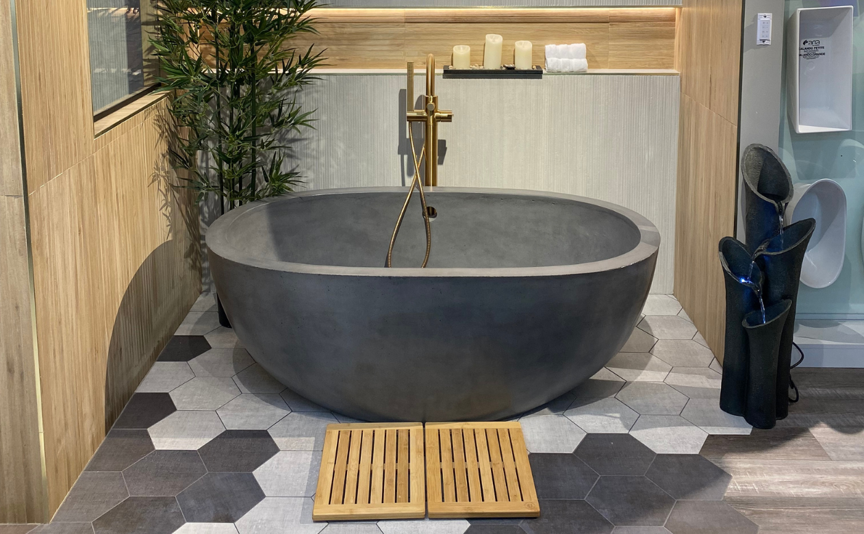 Black free standing tub with a walk-in shower and gold fixtures