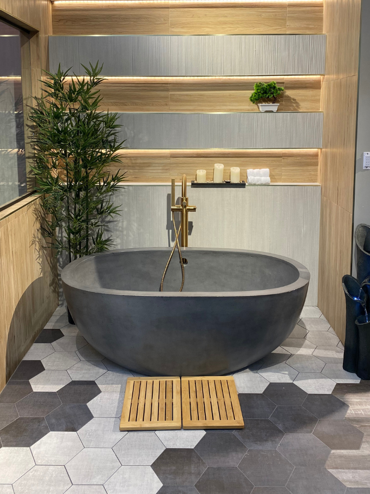Black free standing tub with a walk-in shower and gold fixtures