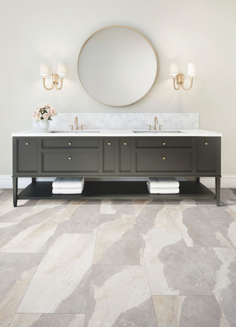 bathroom vanity design with round mirror, gold hardware, and black cabinets
